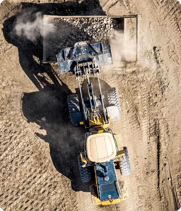 Yellow contruction vehicle driving on construction site